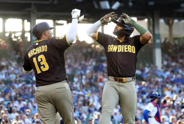 San Diego Padres right fielder Fernando Tatis Jr. (right) celebrates with teammate Manny Machado (13) after Tatis Jr. hit a solo home run in the first inning of a game against the Chicago Cubs at Wrigley Field in Chicago on June 30, 2026. (Chris Sweda/Chicago Tribune)
