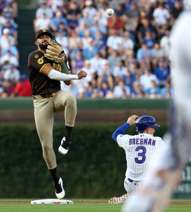 San Diego Padres second baseman Fernando Tatis Jr. follows through on a throw to first base after forcing out Chicago Cubs baserunner Alex Bregman (3) at second base in the first inning of a game at Wrigley Field in Chicago on June 30, 2026. (Chris Sweda/Chicago Tribune)