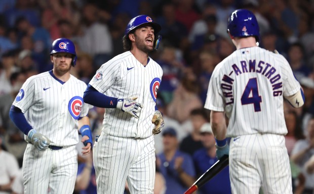 Chicago Cubs shortstop Dansby Swanson (center) celebrates after crossing home plate following his two-run home run in the fifth inning of a game against the San Diego Padres at Wrigley Field in Chicago on June 30, 2026. (Chris Sweda/Chicago Tribune)