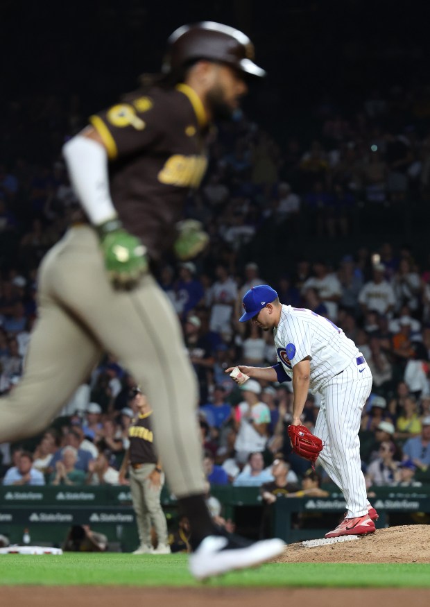 Chicago Cubs relief pitcher Javier Assad stands on the mound as Diego Padres second baseman Fernando Tatis Jr. (left) rounds the bases after Tatis Jr. hit a solo home run in the eighth inning of a game at Wrigley Field in Chicago on June 30, 2026. (Chris Sweda/Chicago Tribune)