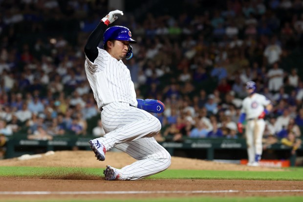 Chicago Cubs designated hitter Seiya Suzuki (27) slides into third base as he advances after a fly ball in the eighth inning of a game at Wrigley Field in Chicago on June 30, 2026. (Chris Sweda/Chicago Tribune)