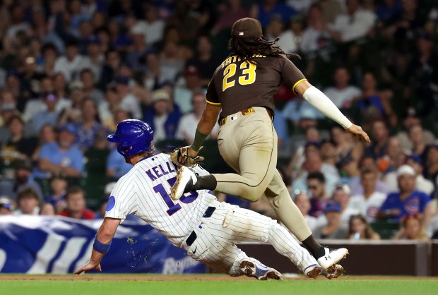 San Diego Padres second baseman Fernando Tatis Jr. (23) tags out Chicago Cubs catcher Carson Kelly (15) between first and second base in the eighth inning of a game at Wrigley Field in Chicago on June 30, 2026. (Chris Sweda/Chicago Tribune)