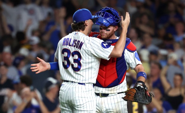 Chicago Cubs relief pitcher Ryan Rolison (33) and catcher Carson Kelly (15) celebrate after securing a victory by closing out the San Diego Padres in the ninth inning of a game at Wrigley Field in Chicago on June 30, 2026. (Chris Sweda/Chicago Tribune)