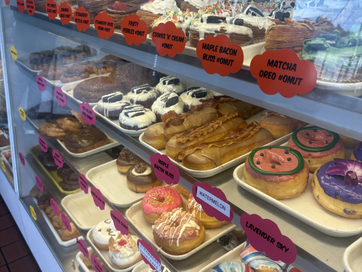 a display case full of many different donuts