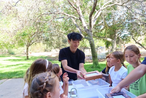 Reiji Osu of BloomInk shows kids how to make recycled paper at Slam Summer Camp at San Dieguito County Park. (Sahana Grover)