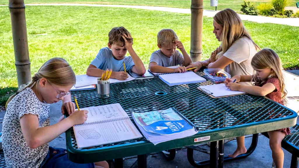 A mom and her children writing