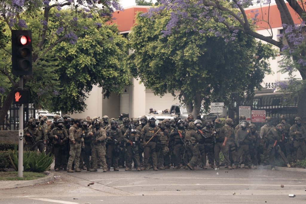 Federal agents wield crowd-control weapons during a protest in Paramount, California, in June 2025. Photo: Jeremy Lindenfeld for Capital & Main.
