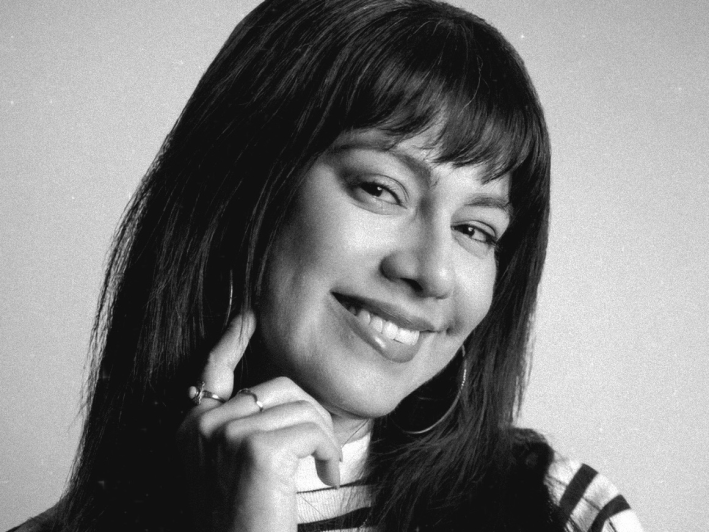 a woman with bangs smiles