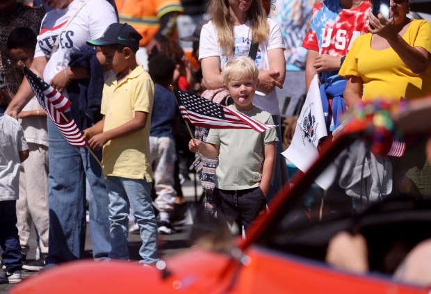Spectators watch as the Alameda 4th of July Parade heads down Park Street in Alameda, Calif., on Saturday, July 4, 2026. (Jane Tyska/Bay Area News Group)