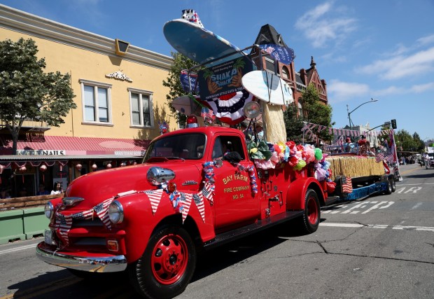A vintage Bay Farm fire vehicle rolls by as the Alameda 4th of July Parade heads down Park Street in Alameda, Calif., on Saturday, July 4, 2026. (Jane Tyska/Bay Area News Group)