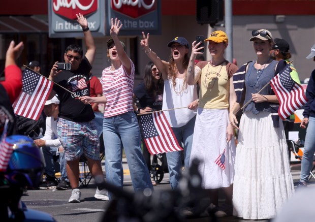 Spectators cheer as the Alameda 4th of July Parade heads down Park Street in Alameda, Calif., on Saturday, July 4, 2026. (Jane Tyska/Bay Area News Group)