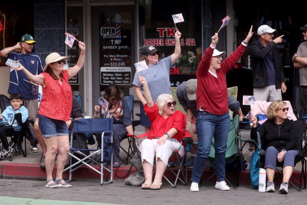Spectators wave as the Alameda 4th of July Parade heads down Park Street in Alameda, Calif., on Saturday, July 4, 2026. (Jane Tyska/Bay Area News Group)