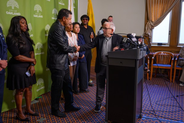 Irving Azoff, Co-founder of Oak View Group, right, shakes hands with Oakland city councilmember Ken Houston during a press conference regarding the Oakland Coliseum sale vote at Oakland City Hall in Oakland, Calif., on Monday, July 13, 2026.(Jose Carlos Fajardo/Bay Area News Group)