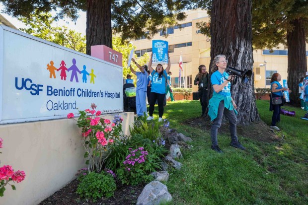 Sstaff, patient families, and healthcare advocates protest during a rally outside UCSF Benioff Children's Hospital Oakland in Oakland, Calif., on Thursday, July 9, 2026. The demonstration opposed the relocation of specialized treatment clinics from the East Bay to San Francisco, which forces vulnerable children battling cancer and sickle cell anemia to rely on public transit for long-distance care. (Ray Chavez/Bay Area News Group)