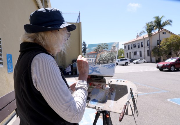 Artist Carolyn Westerman paints a nearby building in a parking lot near Encinal Avenue during the Frank Bette Center for the Arts Plein Air Paint Out in Alameda, Calif., on Wednesday, July 29, 2026. (Jane Tyska/Bay Area News Group)