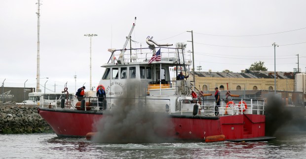 Black smoke billows from the Oakland Fire Department boat "Sea Wolf" as it leaves the Port of Oakland en route to Stockton for private use on Monday, July 27, 2026, in Oakland, Calif. The firefighting boat arrived in Oakland on Sept. 2, 1994, and was removed from service in 2003. (Aric Crabb/Bay Area News Group)