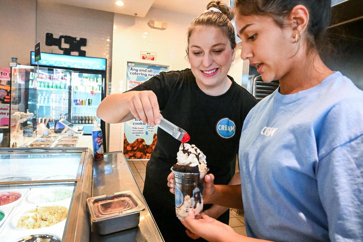 Amanda Vogel and her daughter Jazmyn Sandhu, put the finishing touches on a brownie and ice cream sundae at CREAM’s first locationnear Fresno State. They’ve opened a second location at Marks and Bullard avenues.