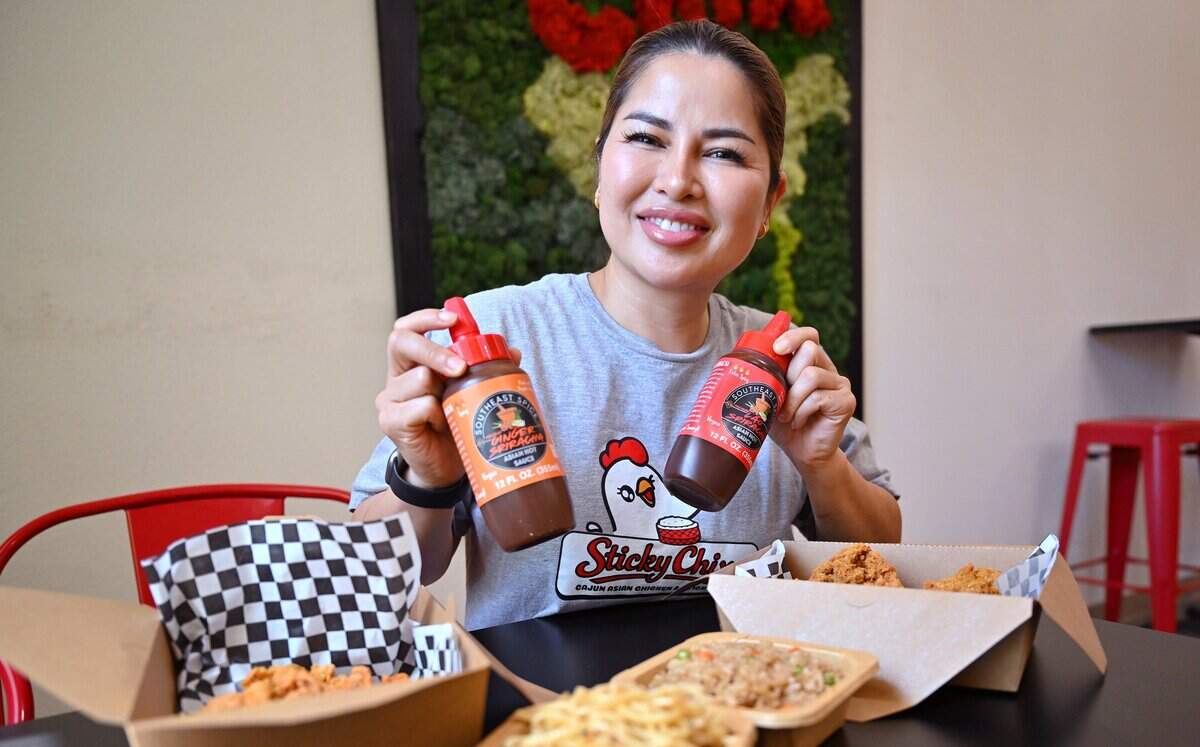 Davanh Phayarath-Khamsone shares her new sriracha sauces she developed for her Cajun-inspired Asian restaurant Sticky Chix, which features fried chicken and sticky rice. Photographed Tuesday, July 28, 2026 in downtown Fresno.