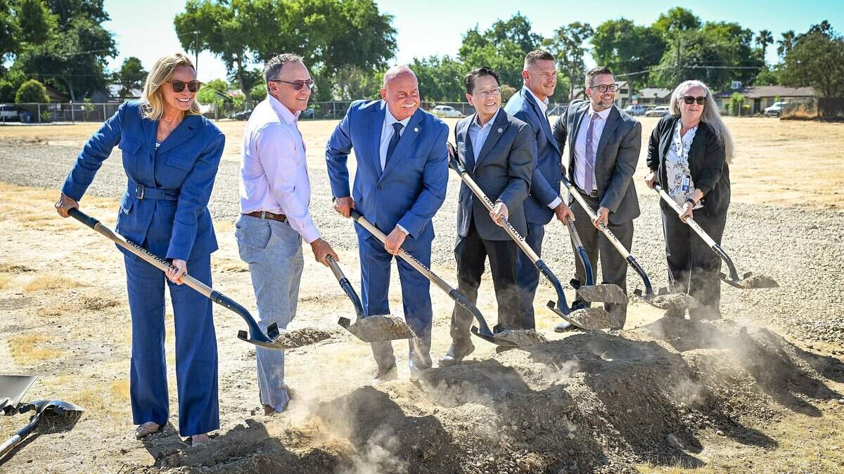 Fresno Mayor Jerry Dyer, Councilmember Brandon Vang and other dignitaries and interested parties pose with shovels of dirt during a groundbreaking ceremony to begin construction on an affordable apartment complex on a decades-long empty lot on Ventura Avenue east of downtown Fresno on Friday, July 24, 2026.