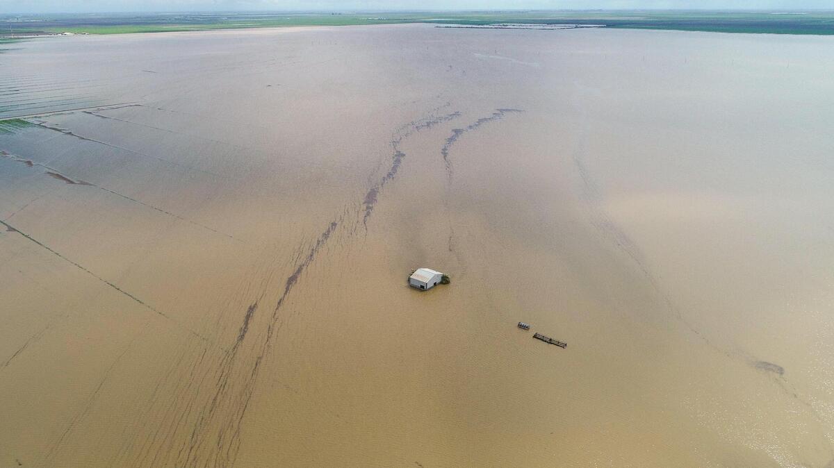 A barn is dwarfed by vast floodwaters in the old Tulane Lake basin area of Kings County south of Corcoran. The historic floods and the continuing aftermath has been one of the most impactful stories of the 2023. A barn is dwarfed by vast floodwaters in the old Tulane Lake basin area of Kings County south of Corcoran. The historic floods and the continuing aftermath has been one of the most impactful stories of the 2023.