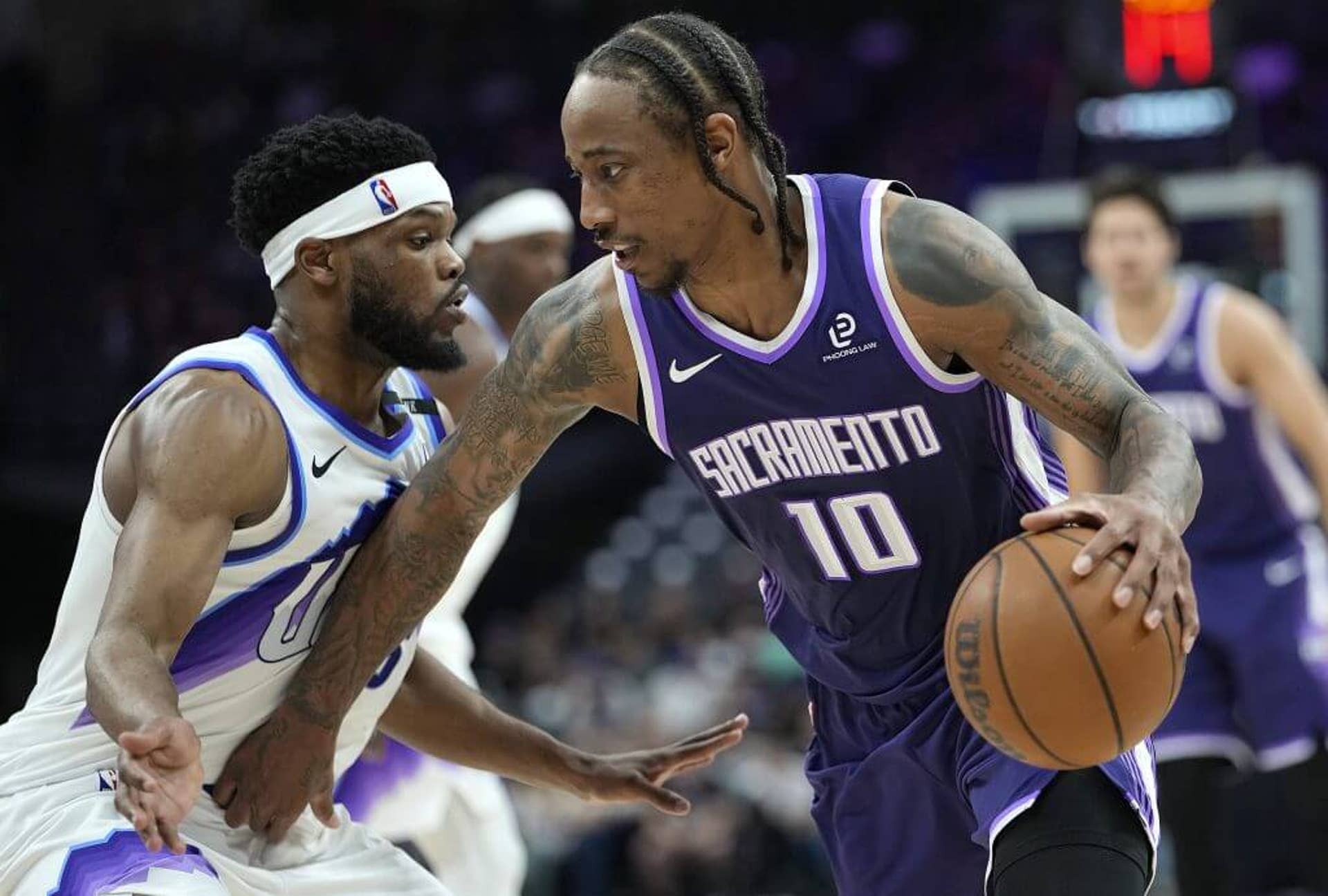 DeMar DeRozan dribbles past Elijah Harkless during a Kings game against the Jazz game last season.