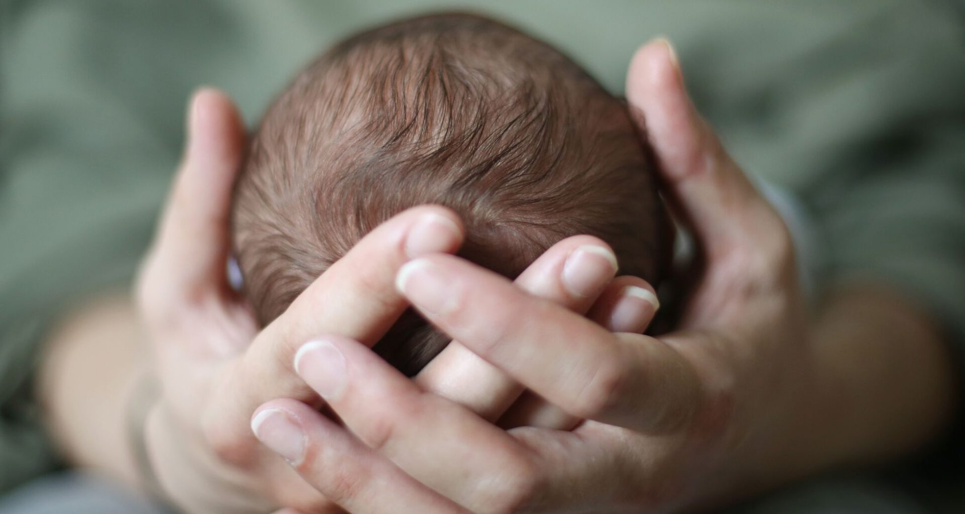 baby head in hands