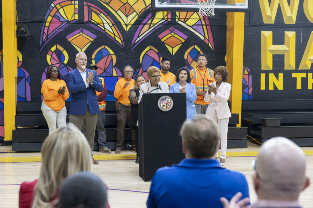 Mayor Bass is joined by Congresswoman Maxine Waters, leaders from HACLA and LADWP, and residents at Nickerson Gardens gymnasium, underscoring the City's commitment to climate resilience and environmental justice.