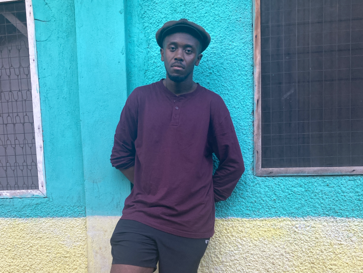 a man leaning against a wall