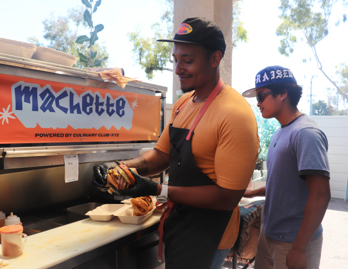 a man wraps a sandwich order up