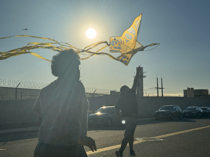two people fly a kite