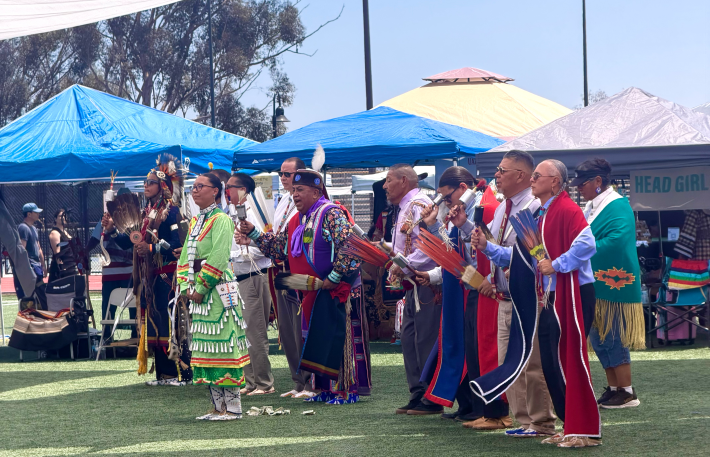 Indigenous leaders lined up outside for opening powwow chants