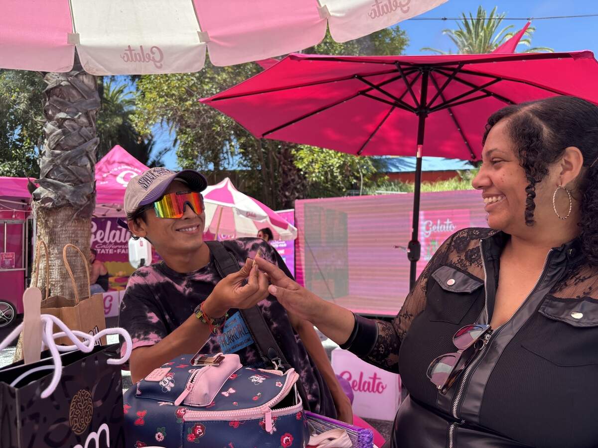 Bryan Galan and Kassy Burpee share a pre-rolled joint at the Gelato activation within the California State Fair cannabis consumption area on Saturday.