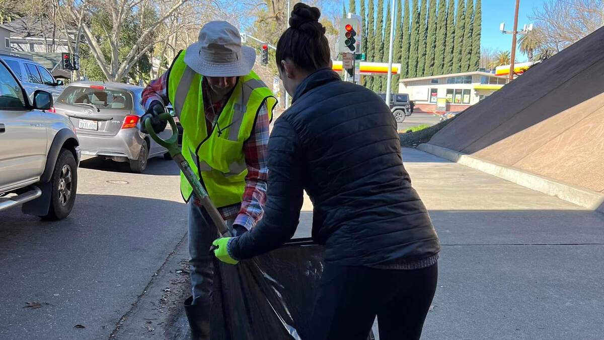 Volunteers work to clean up used syringes and other trash in Sacramento.
