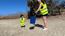 Sadi Richard and her son, Koa, 2, volunteered to clean up Fiesta Island, Sunday, along with others concerned about the environment, San Diego, Calif., July 5, 2026.