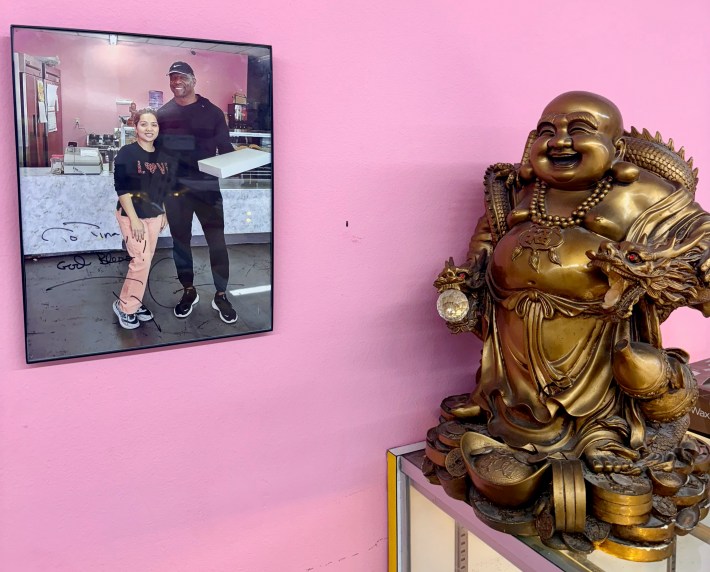 A framed photo of Terry Crews and the owner of Mr Goods Donuts in Pasadena hangs next to the donut counter.