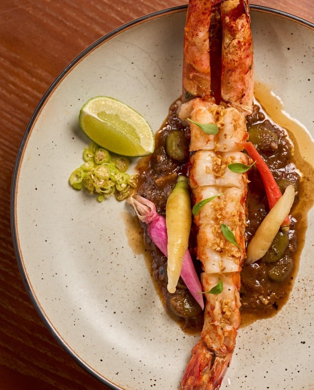A single shrimp over sauce from Saam in San Francisco.