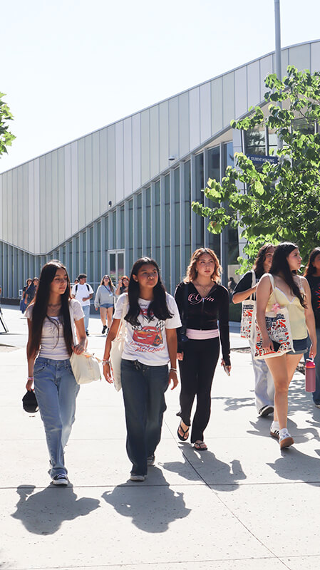 High school students in the GEAR UP program walk outside Titan Dining Hall. 