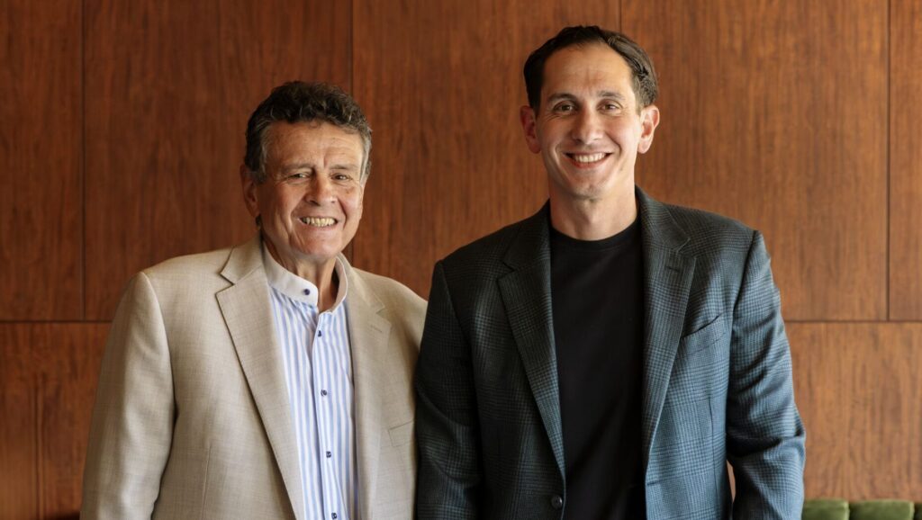 Two men smile