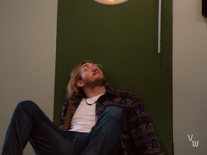 a man sitting on the floor against a door