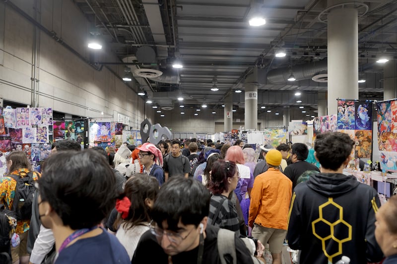 Attendees walking in a crowded area