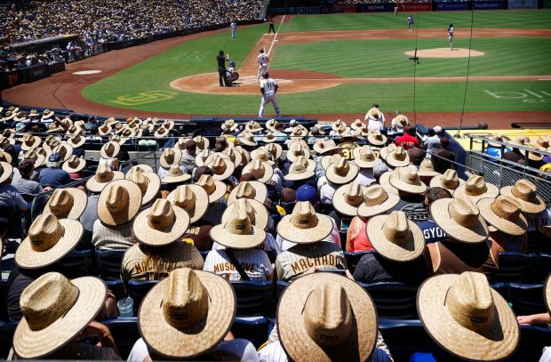 The Dodgers play in front of thousands of fans wearing straw hats that was a giveaway at Petco Park on Monday, August 7, 2023, in San Diego as the Los Angeles Dodgers played the San Diego Padres. (K.C. Alfred, The San Diego Union-Tribune)