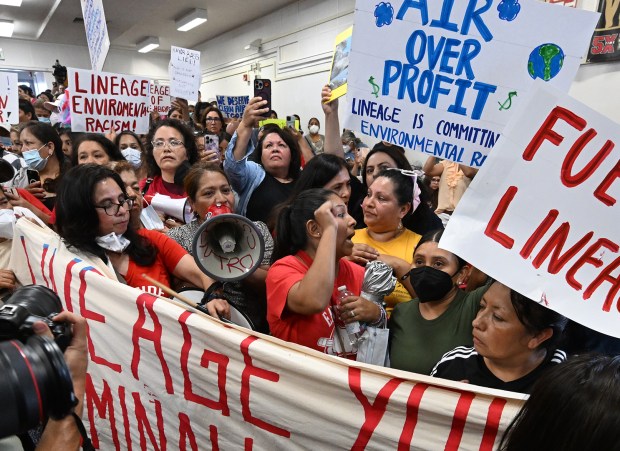 Demonstrators enter the auditorium where Los Angeles Mayor Karen Bass, County Supervisor Hilda Solis and City Councilwoman Ysabel Jurado participated in a community meeting at Stevenson Middle School to give an update on the cleanup of the Lineage warehouse fire on July 9, 2026, in Boyle Heights. (Photo by John McCoy, Contributing Photographer)