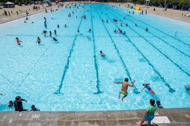 A child jumps into the swim lagoon as families and visitors enjoy a summer day at the Hansen Dam Aquatic Center in Lake View Terrace, California, Saturday, June 20, 2026. (Photo by Mark Savage, Contributing Photographer)