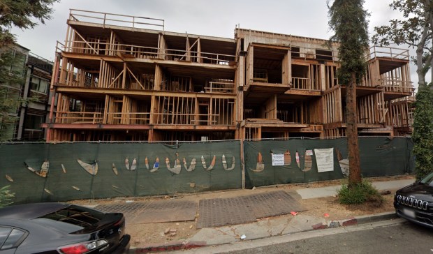 The abandoned construction site, now dubbed the Coyote Condos, by neighbors, sits at Spaulding Avenue and Romaine Street in West Hollywood. Construction on the complex stopped in 2024, and permits to continue the work have expired. (Google Street View)