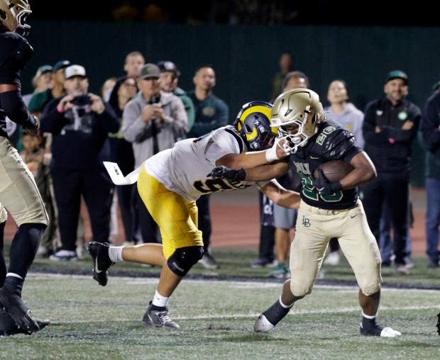 Millikan's Jesse Laumasima cant stop Long Beach Poly's Elijah Dawson (26) as he runs it in for a Jackrabbit touchdown in Long Beach, CA, on Friday, Oct. 10, 2025. (Photo by Tracey Roman, Contributing Photographer)