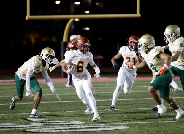 Wilson's Kyle Harris (6) races through Long Beach Poly's defense as the two teams battle for the top spot in the Moore League in Long Beach, CA, on Friday, Oct. 17, 2025. (Photo by Tracey Roman, Contributing Photographer)