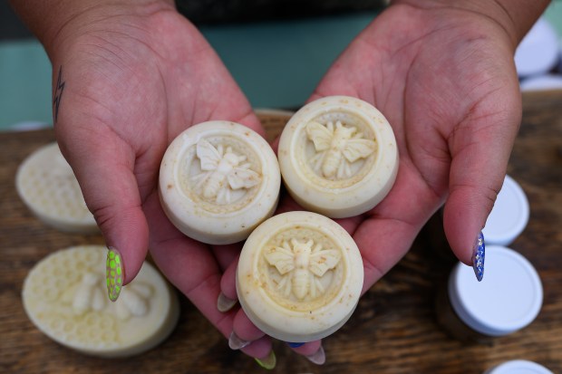 Miss Bee Haven Honey employee Karlee Rosalez holds a handful of honey oat soaps sold at their booth while at the Martinez Farmers Market in Martinez, Calif., on Sunday, June 14, 2026. (Jose Carlos Fajardo/Bay Area News Group)