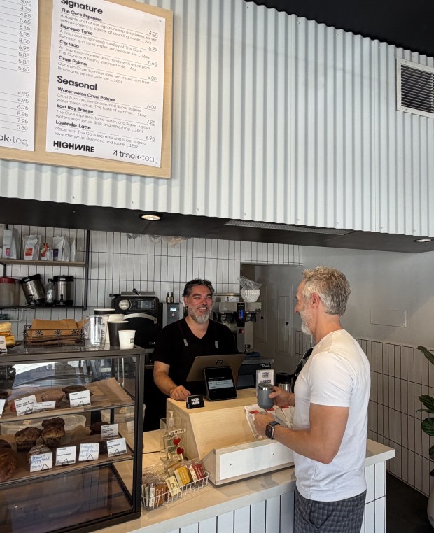 Highwire Coffee has reopened its location in the Oakland hills' Montclair Village, where customer Bryan Edelman recently orders from manager Vinn McIntosh. (Ginny Prior for Bay Area News Group)