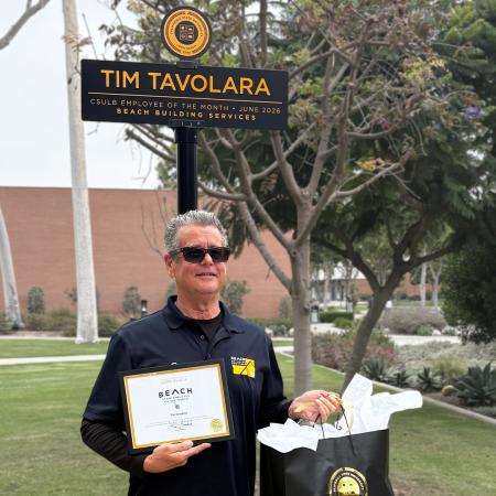 Tim Tavolara standing in front of Employee of the Month sign Tim Tavolara standing in front of Employee of the Month sign
