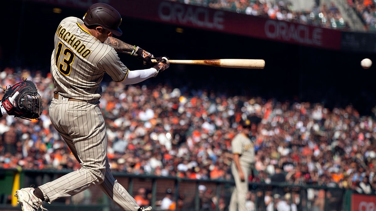 San Diego Padres' Manny Machado (13) lines an RBI single against the San Francisco Giants